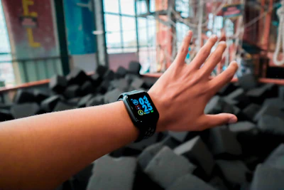 person wearing black Apple Watch with black Sport Band displaying 03:25 time