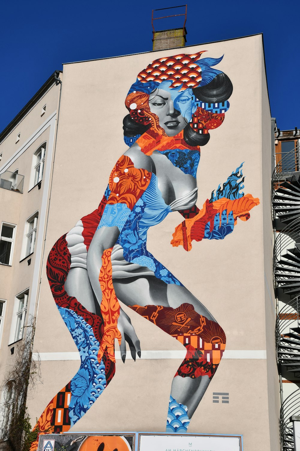 woman painting on building