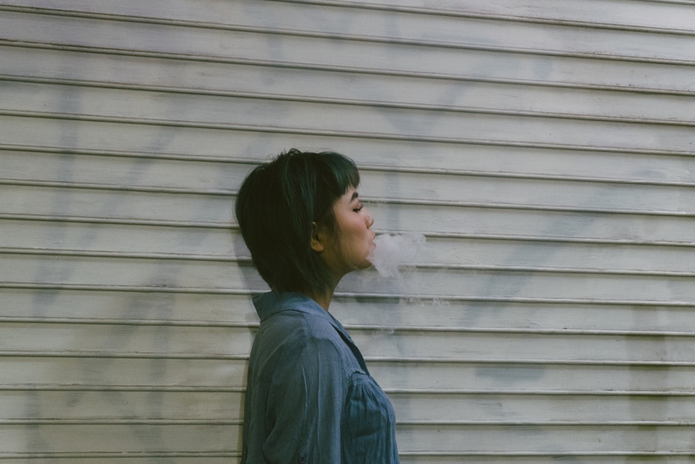 smoking woman wearing blue top