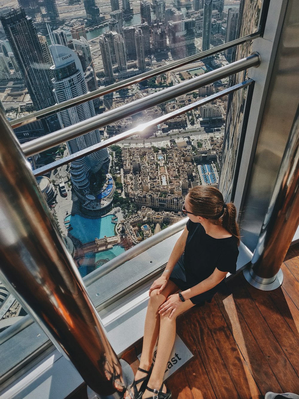 woman sitting beside window glass building