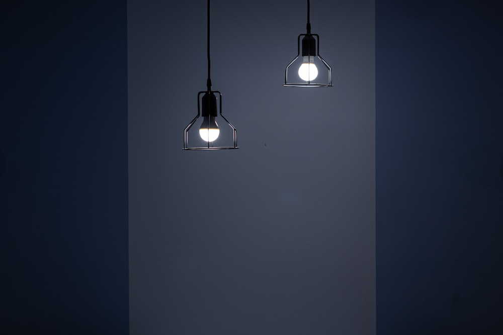 two turned on pendant lamps