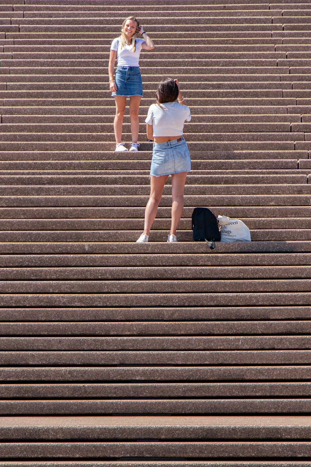 two women standing on stairs