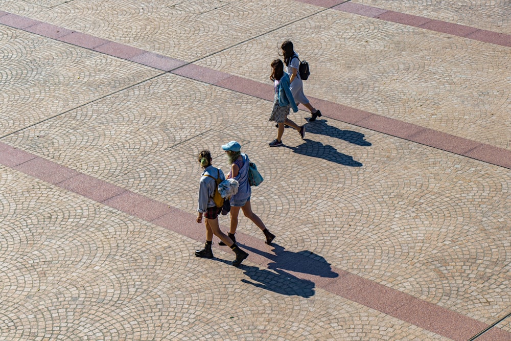 four women walking in street during daytime
