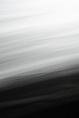 Abstract blurred lines creating a gradient from white to black, with smooth transitions and a sense of motion.