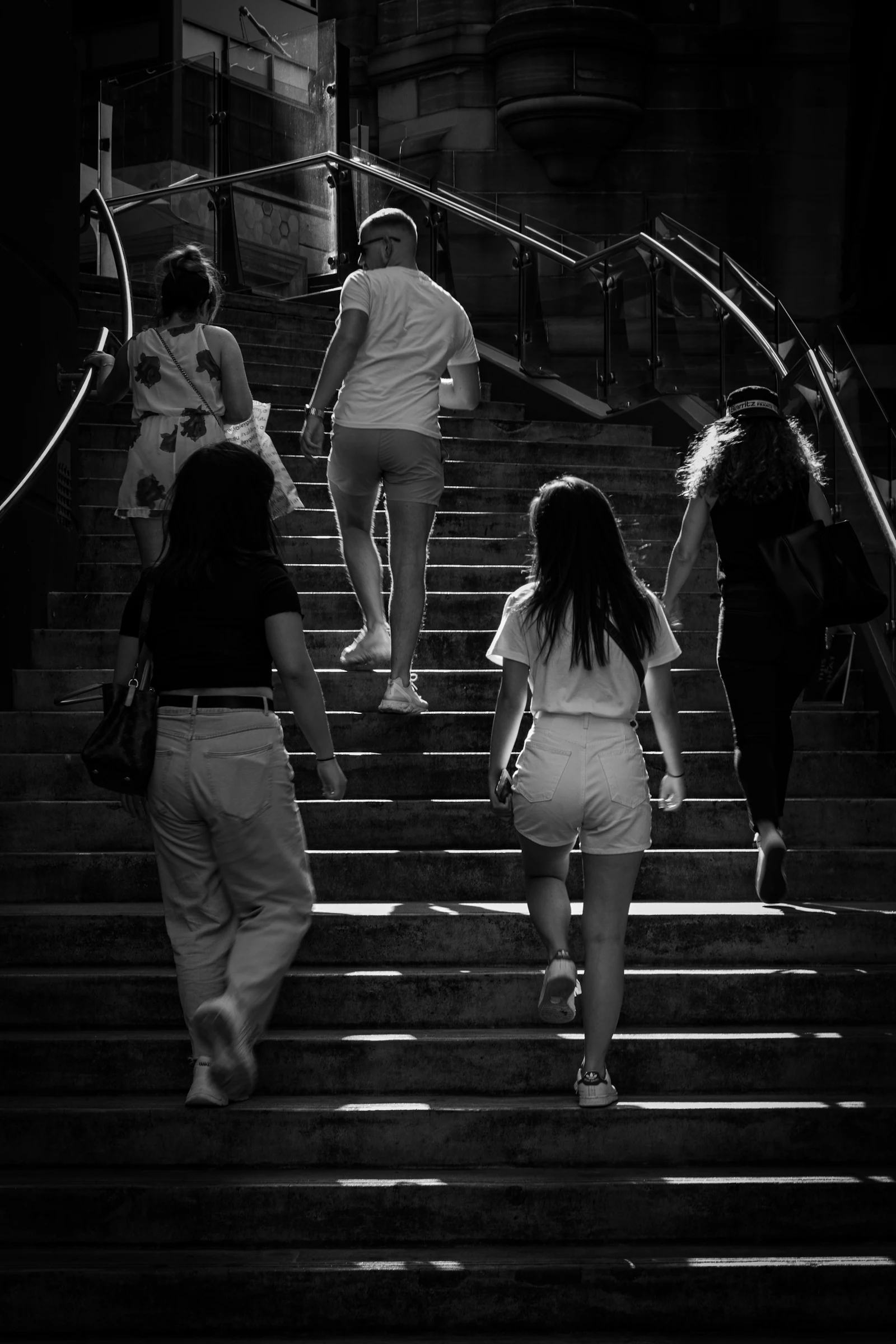 Black and white photograph of commuters walking up stairs in Sydney