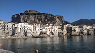 A scenic coastal town with tourists enjoying local attractions on a sunny day.