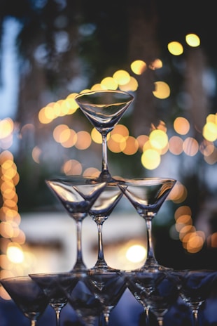 Elegant tiramisu champagne glass pyramid glowing softly in warm wedding lighting