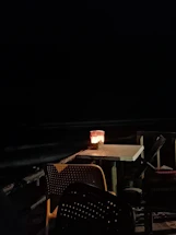 A cozy restaurant table set for a small group, bathed in warm evening light