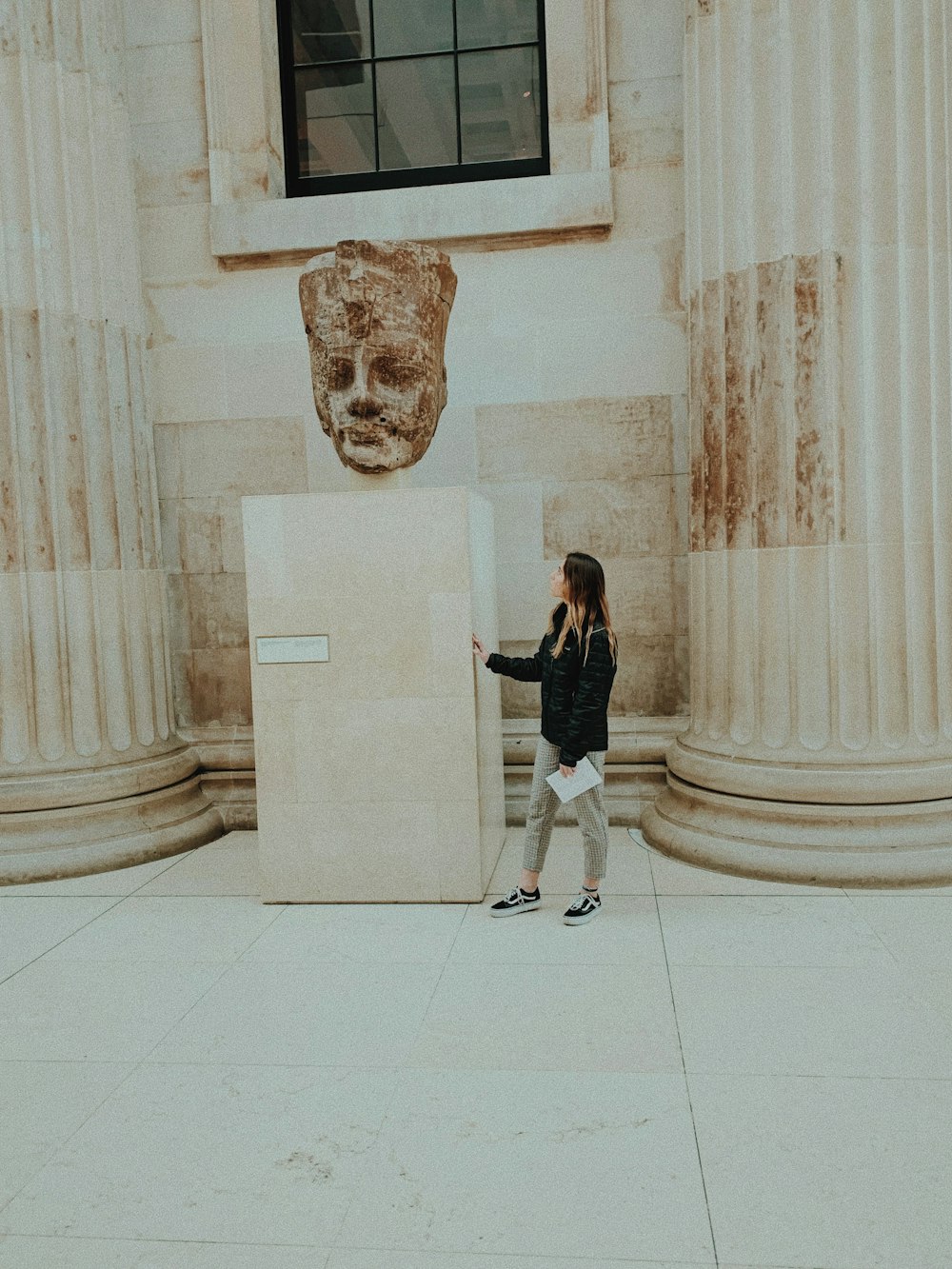 Frau steht in der Nähe von Skulptur