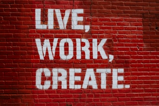 Live, Work, Create. graffiti on brick wall