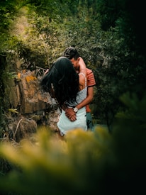 Couple enjoying a relaxing massage outdoors surrounded by forest greenery.