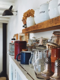 clear glass s jars and gray stainless steel condiment shakers on rack
