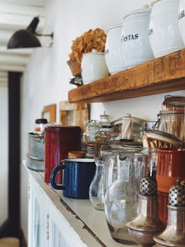 clear glass s jars and gray stainless steel condiment shakers on rack
