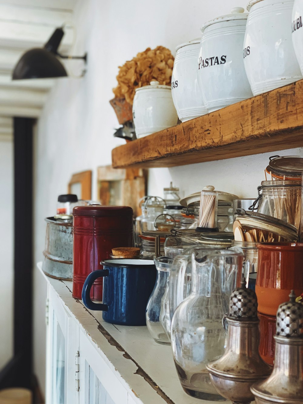 clear glass s jars and gray stainless steel condiment shakers on rack