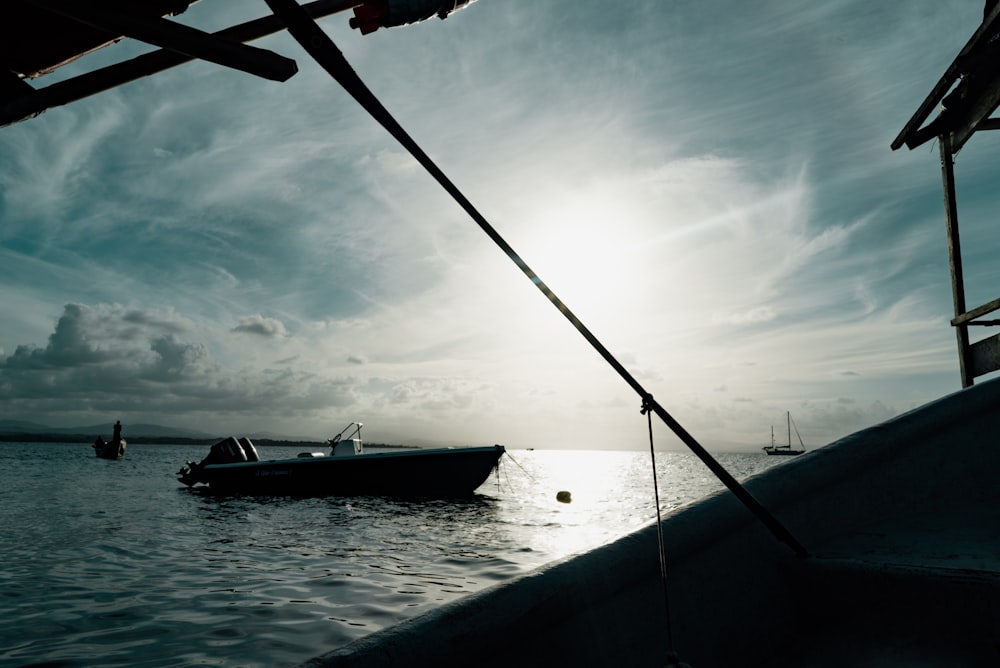 silhouette photography of boat on body of water