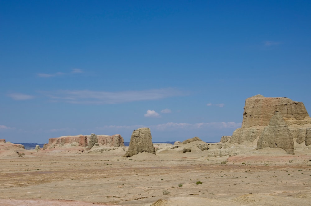 a desert landscape with rocks and a blue sky