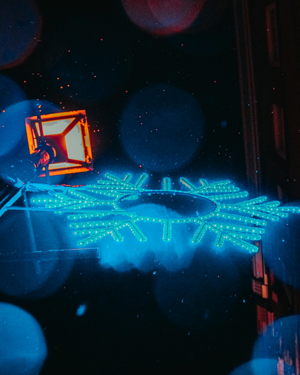 a neon snowflake is shown in the dark