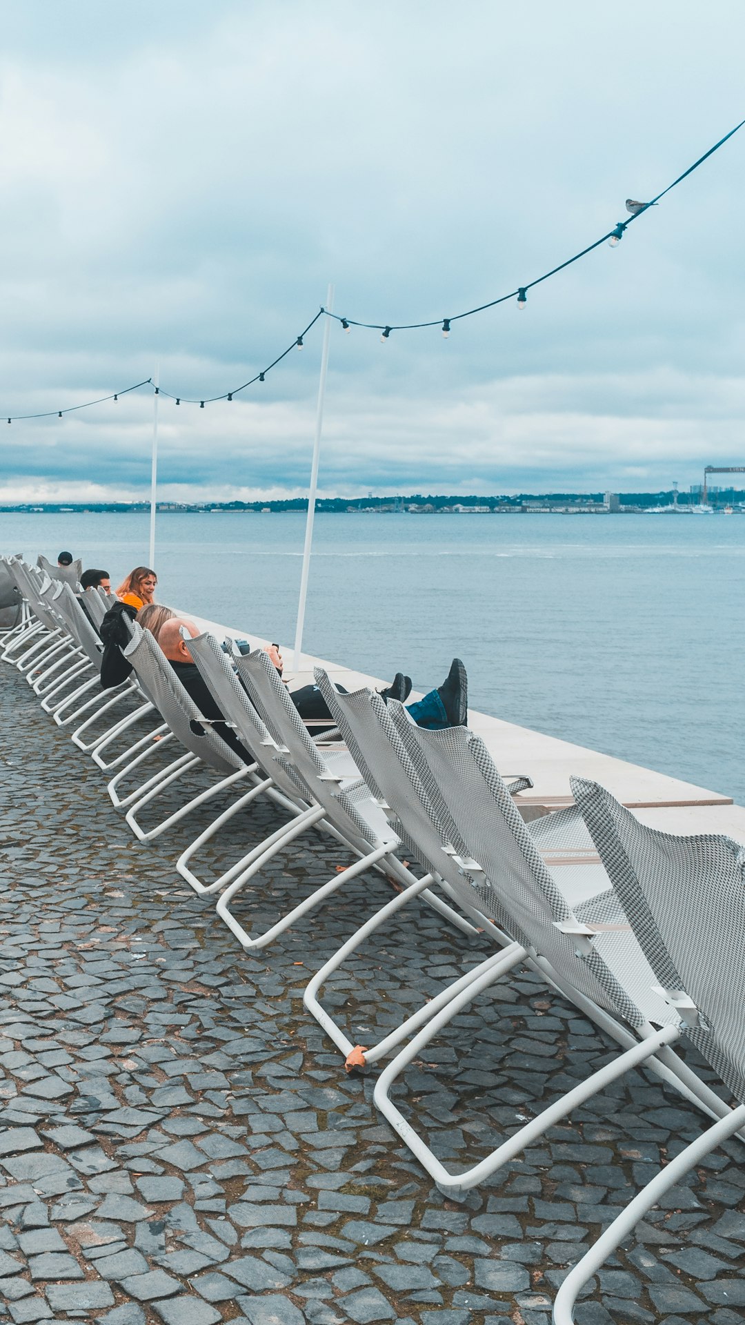 people sitting near body of water