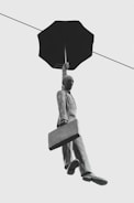 floating man holding umbrella statue