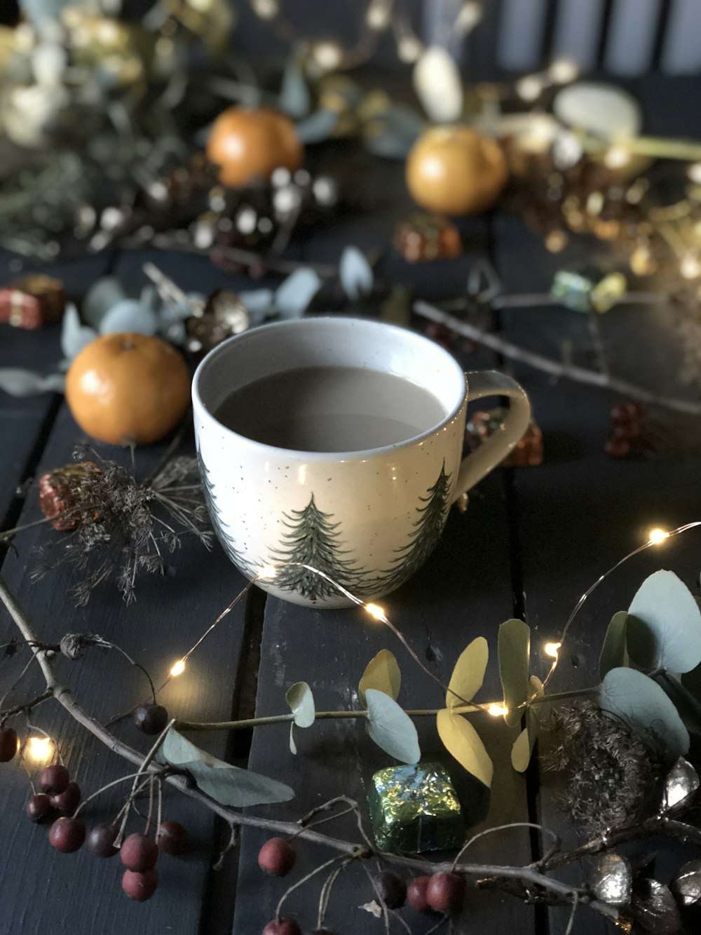 white teacup beside string lights