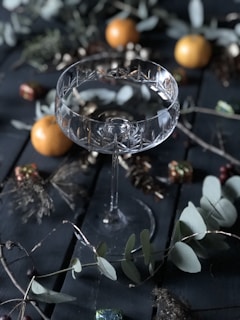 a glass of wine sitting on top of a wooden table