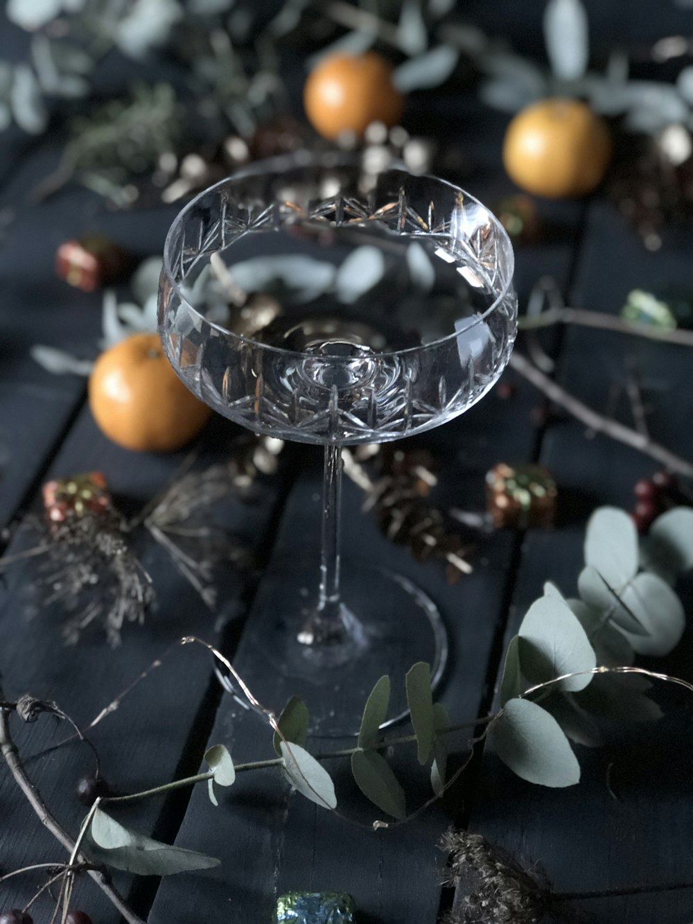 a glass of wine sitting on top of a wooden table