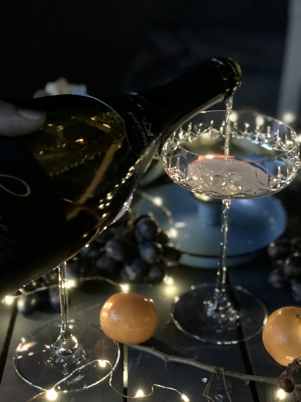 person pouring wine on glass