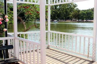 Guests enjoying a peaceful morning on a porch overlooking calm waters.