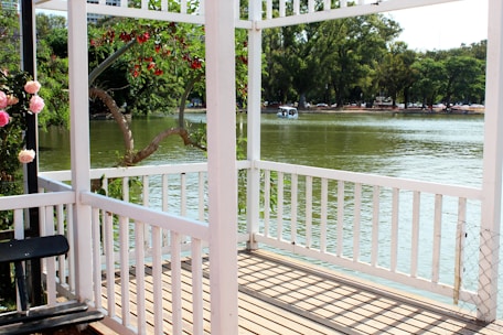 Guests enjoying a peaceful morning on a porch overlooking calm waters.