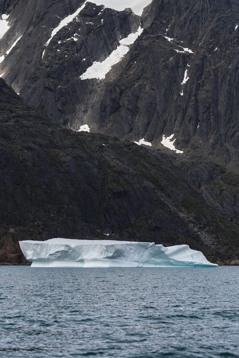 a large iceberg floating on top of a body of water