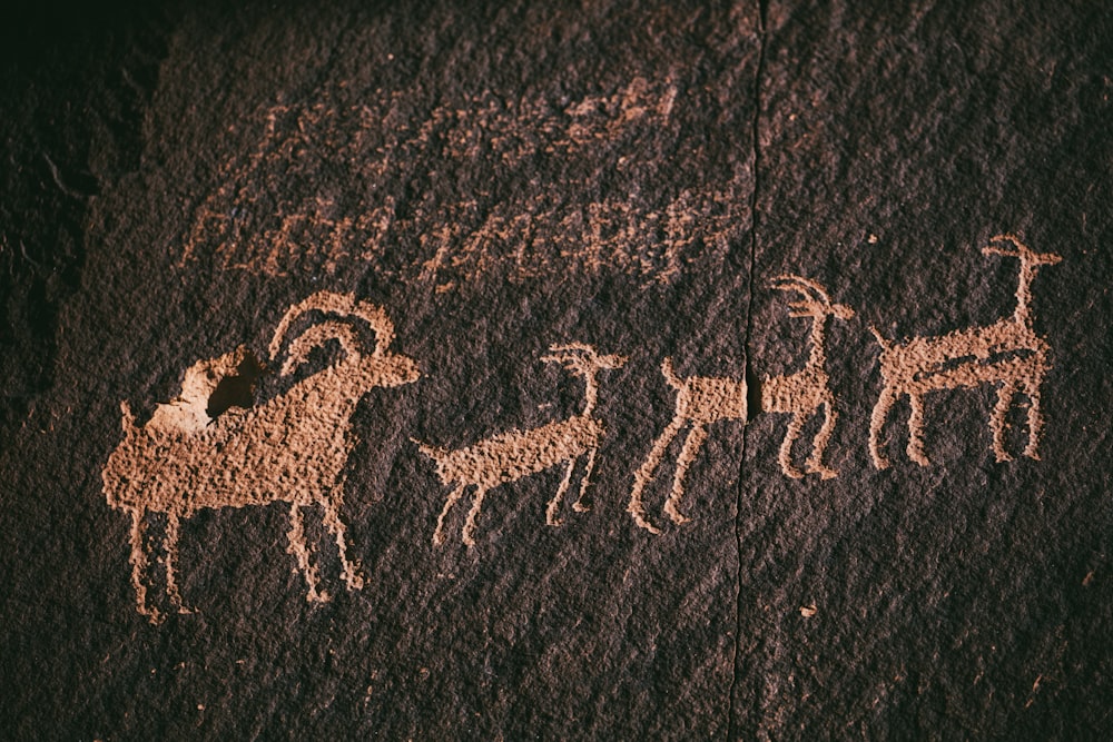 a group of animals painted on a rock