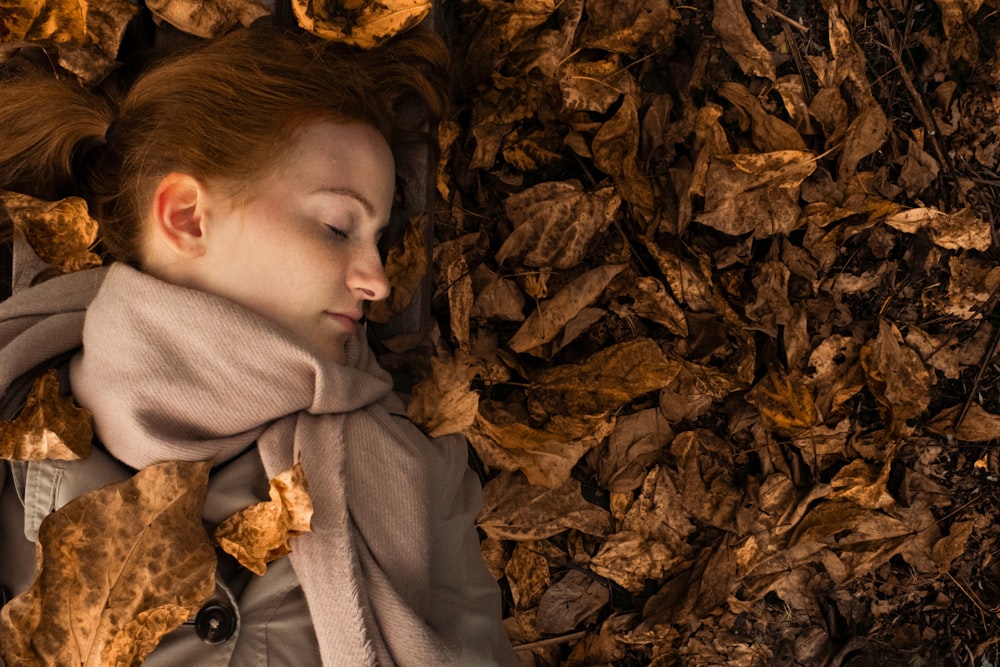 woman lying on leaves