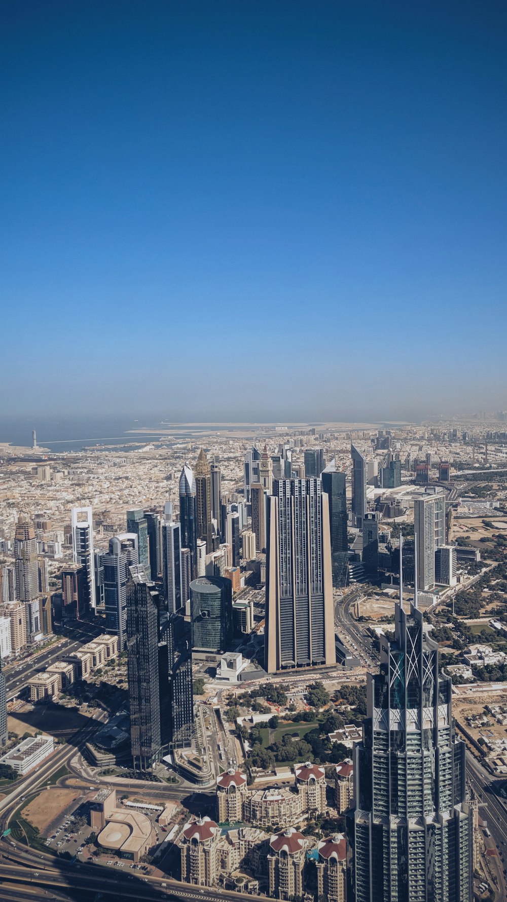 high-angle photography of high-rise buildings under clear blue sky