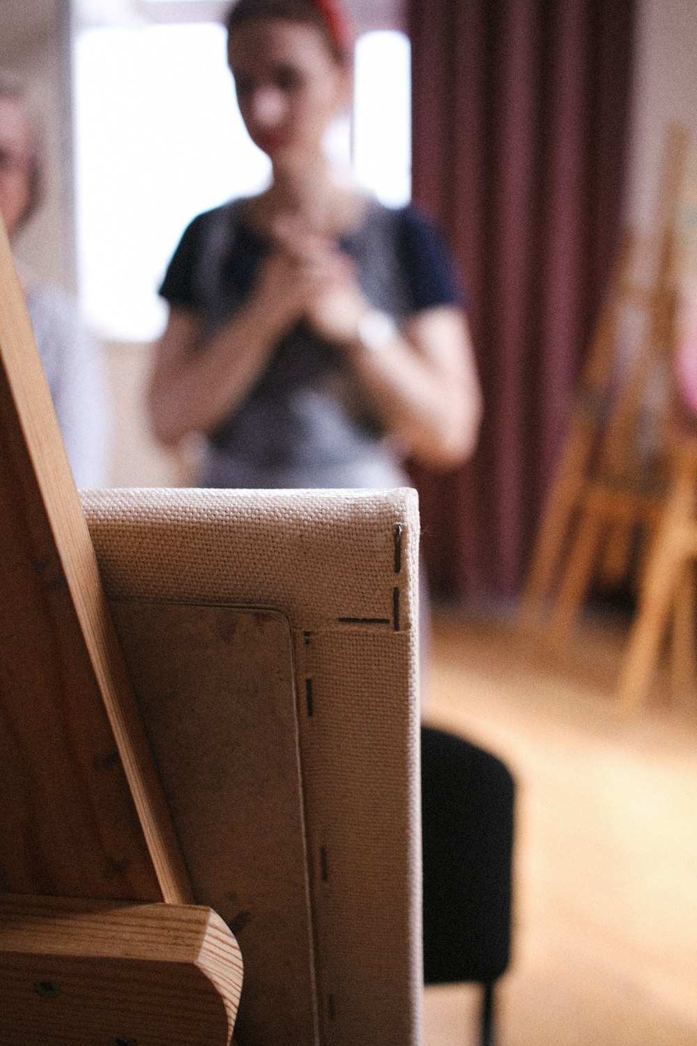 a woman standing in a room next to a chair