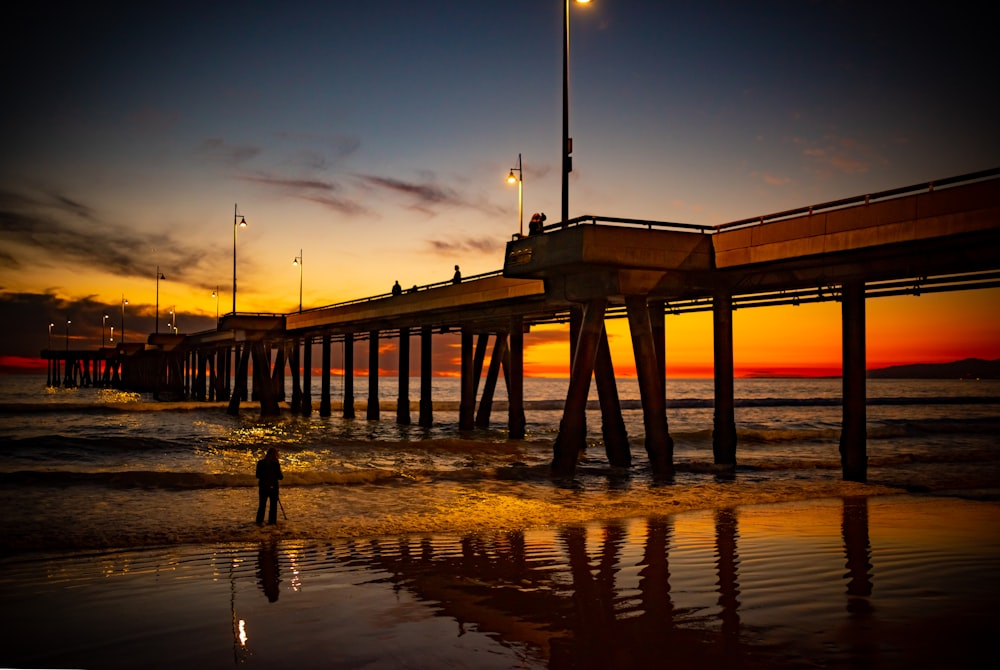 dock during low tide during sunset