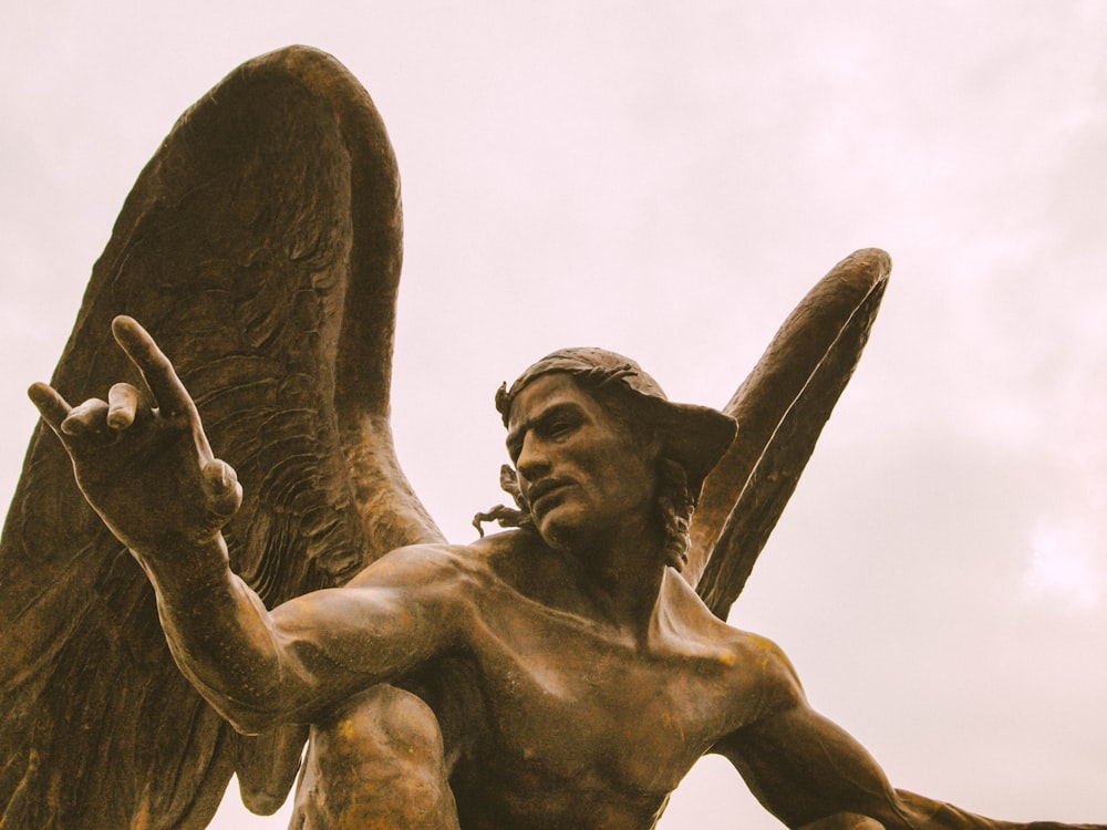 man with angel wing concrete statue