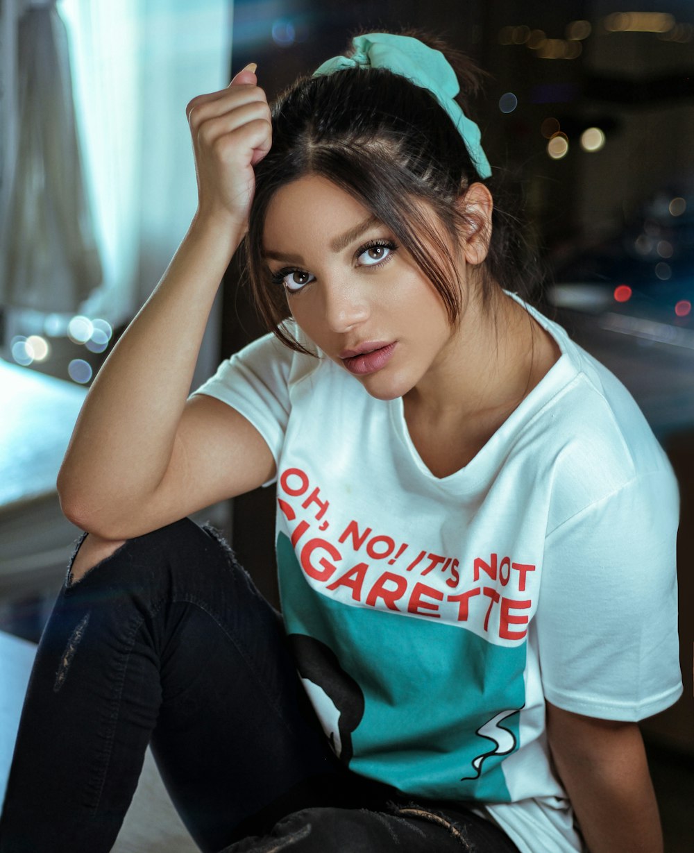 woman wearing grey and teal t-shirt