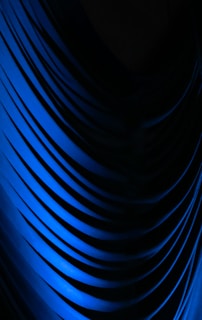 a black and blue background with wavy lines