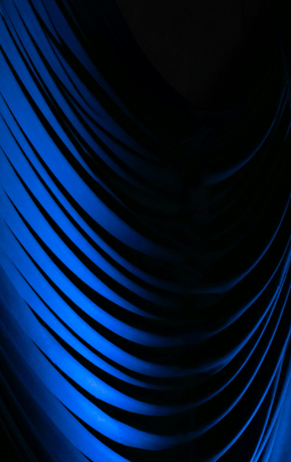 a black and blue background with wavy lines