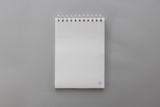 A close-up of a custom notepad featuring a customer's photo printed clearly on the front.