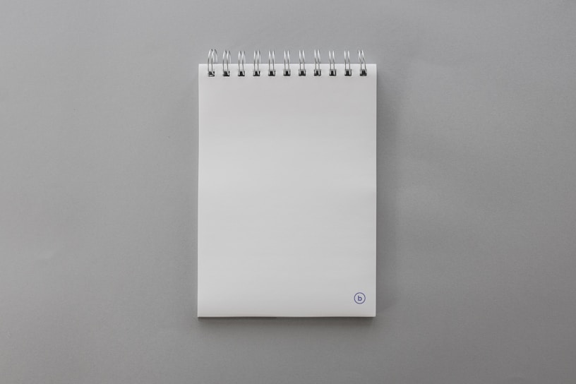 Close-up of a premium notepad with smooth, crisp white pages and a sturdy cover.