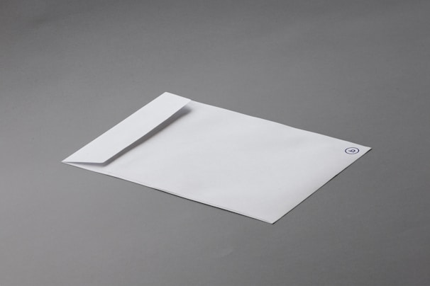 A sleek branding package featuring a minimalist logo on various stationery items.