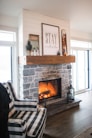 two black sconce lamps near fireplace