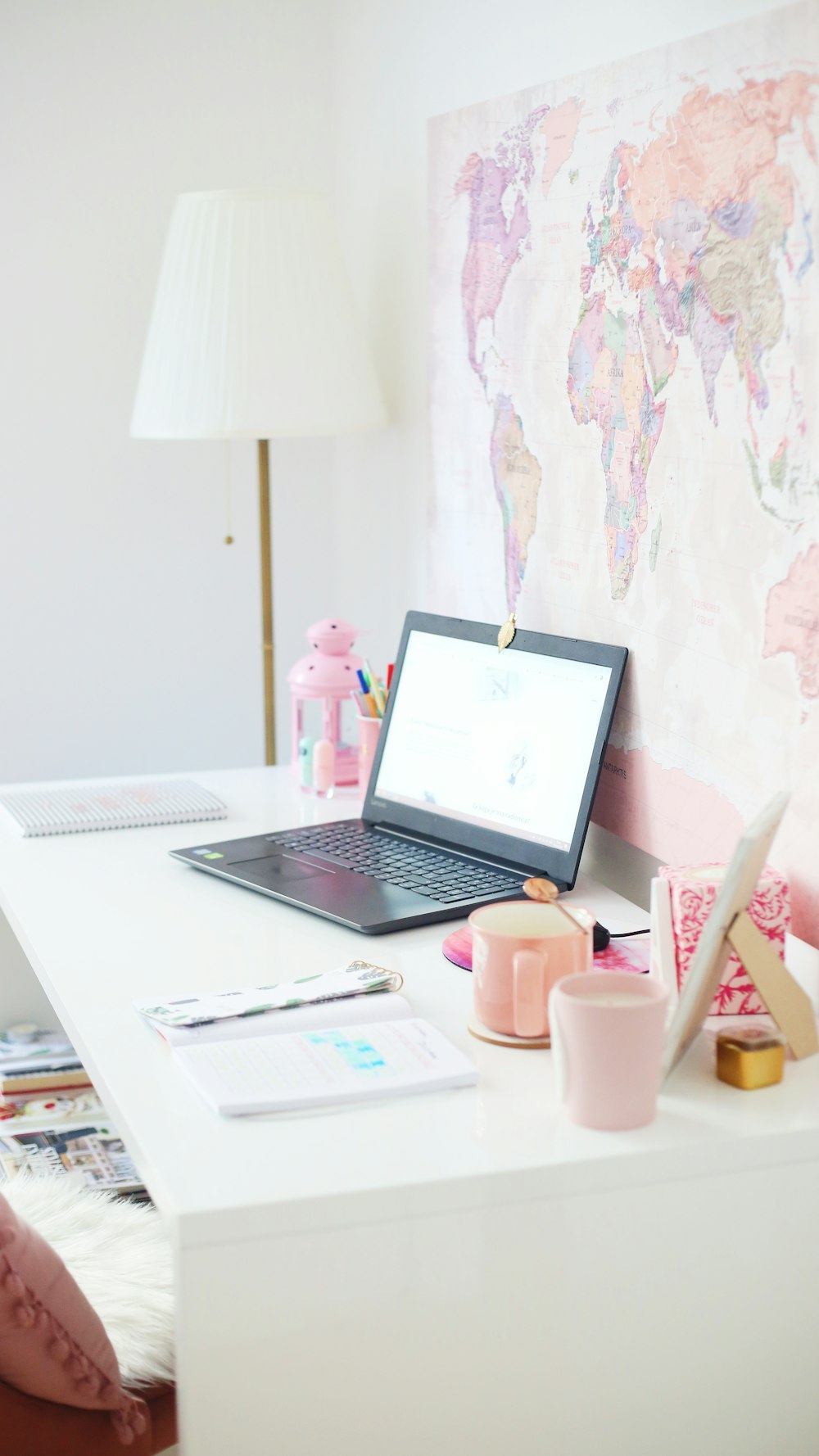 turned-on laptop on white desk