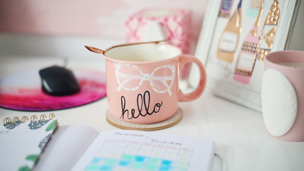 pink, white, and black Hello mug