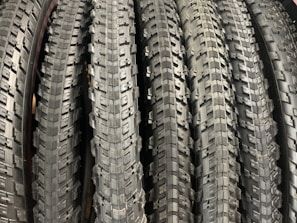 Set of new and secondhand motorbike tires stacked neatly