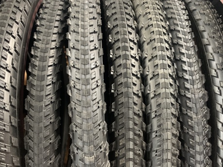 Close-up of various bicycle tires displayed in a bike shop
