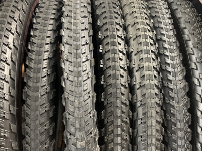 A selection of motorcycle tires neatly arranged in a workshop.