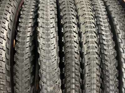 A close-up of various tire treads displayed neatly on store shelves.