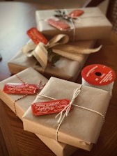 four brown boxes wrapped for christmas